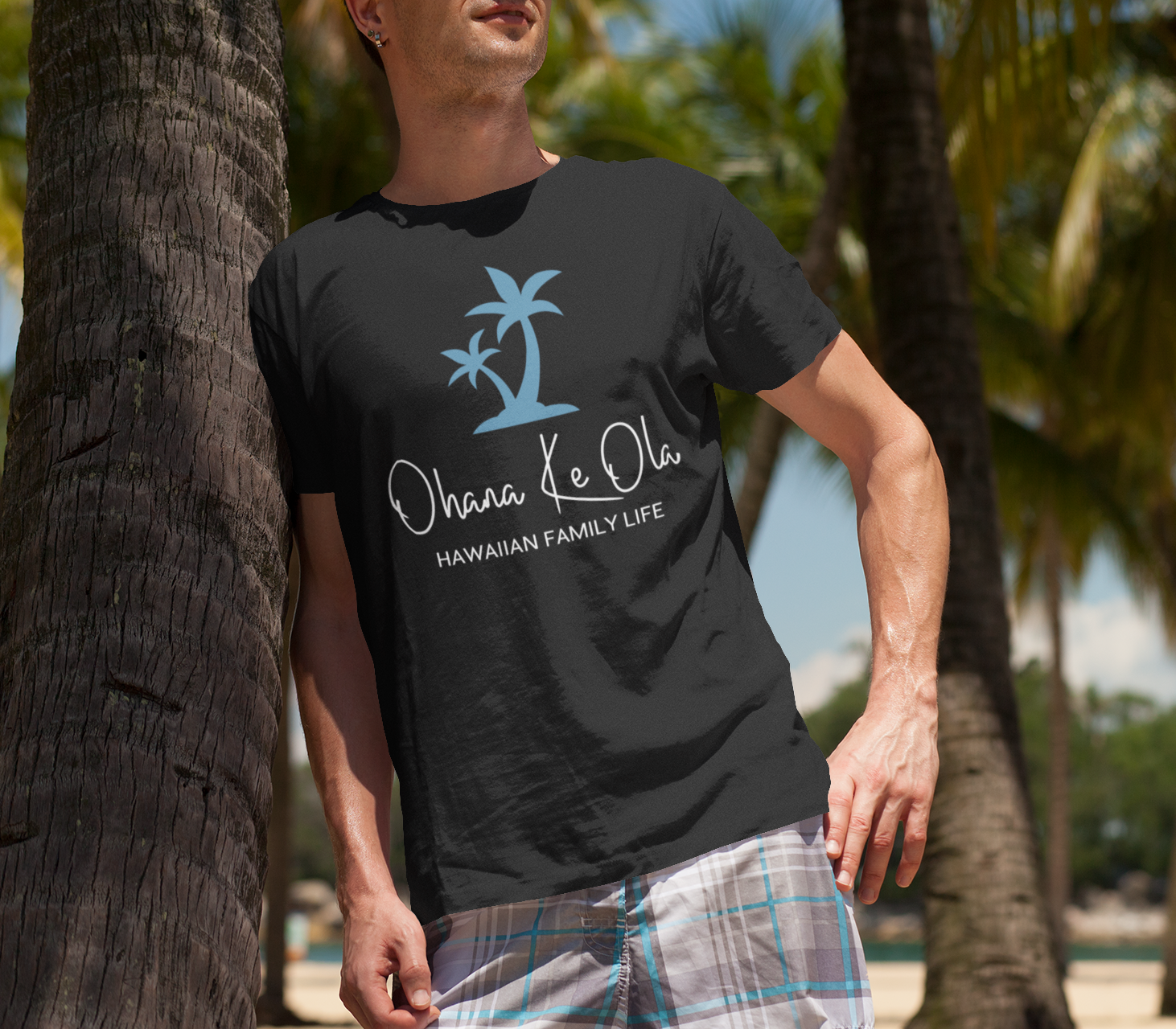 t-shirt-mockup-of-a-man-at-the-beach-leaning-on-a-palm-tree-2750-el1.png